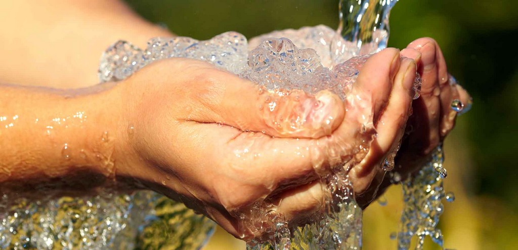 Woman's hands with water splash